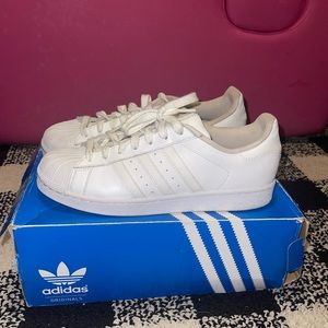 White Adidas Shell Toe Sneakers.